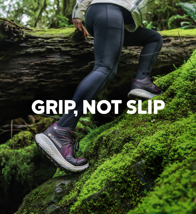 Grip not slip. A woman climbing over a fallen log wearing omni max shoes. 