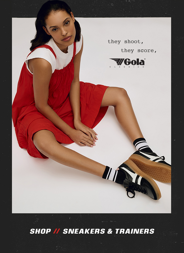 Woman wearing red dress and black and white Gola sneakers. Shop sneakers and trainers.