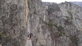 Matt Karlson and Chris Ward of the NROCKS Outdoor Center on a suspension bridge, Circleville, W.Va., March 24, 2015.