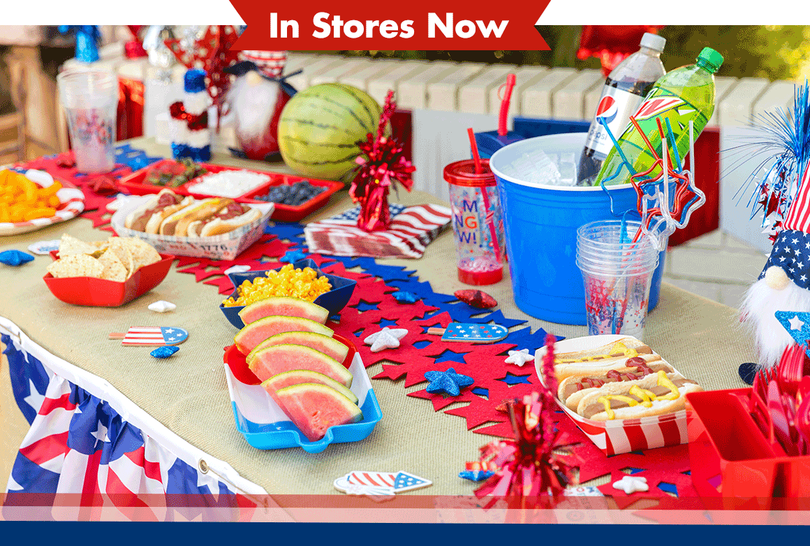 Patriotic table spread of grilled food, snacks, table decorations, and more