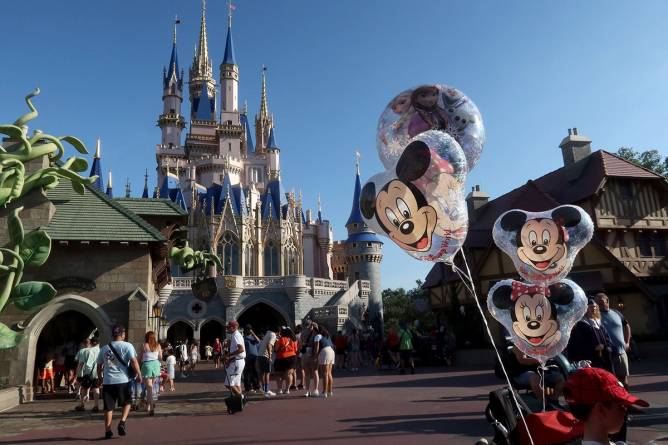 Disney Park full of people in front of Magic Kingdom.