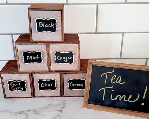 Blog idea: tea bag organizer made from wooden squares stacked on a kitchen counter with a chalk sign that says &#x22;tea time&#x22;