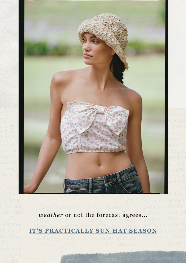 Woman wearing straw hat. Shop hats.