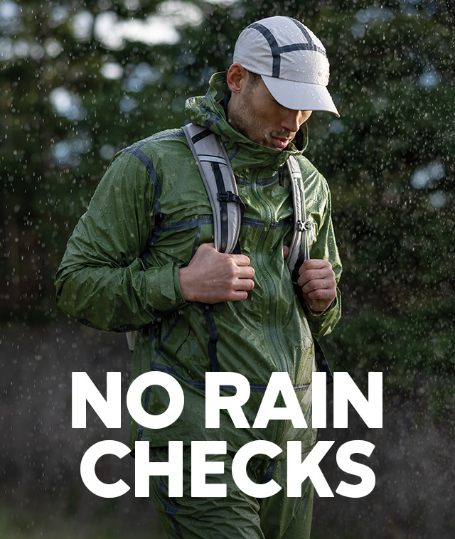 A man hiking in the rain with No Rain Checks over the image.