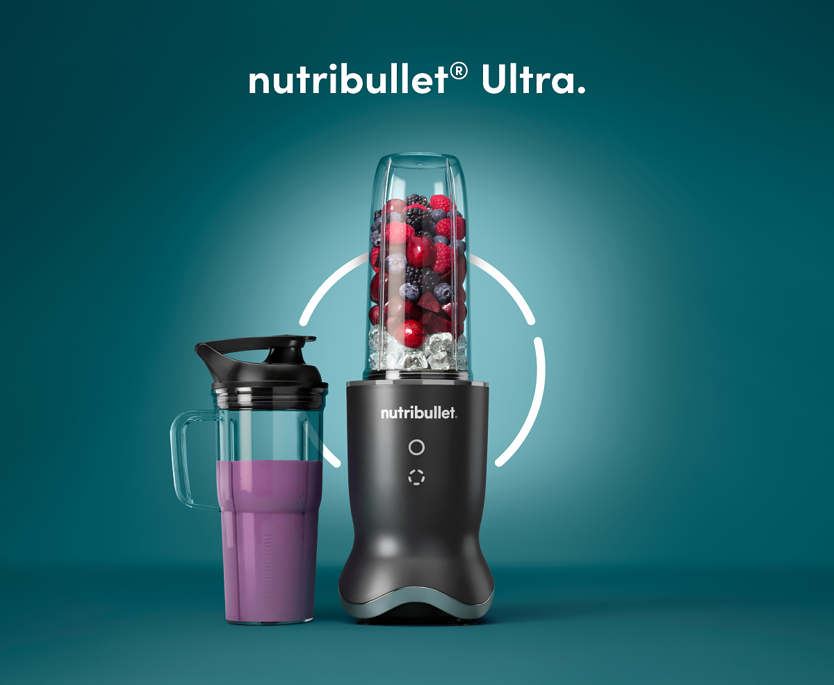 nutribullet Ultra filled with fruits and ice next to a 24 Oz handled cup