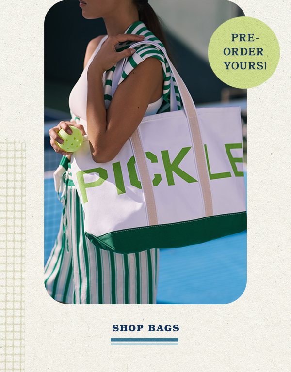 Woman carrying a pickleball tote. Preorder yours. Shop bags.