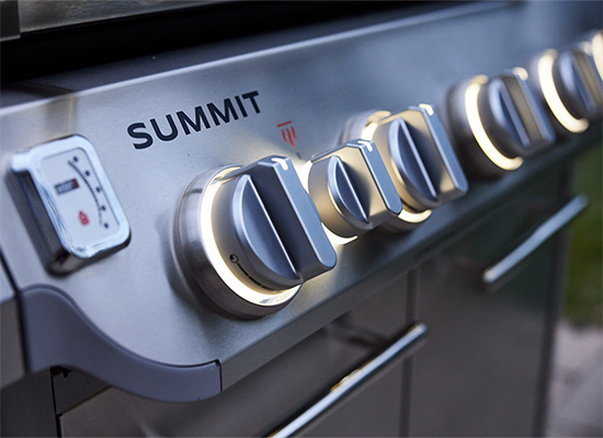 image of Grill lighting and elegant backlit-LED knobs cast a warm glow on nighttime grilling.