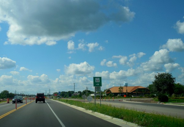 A car drives down a highway.