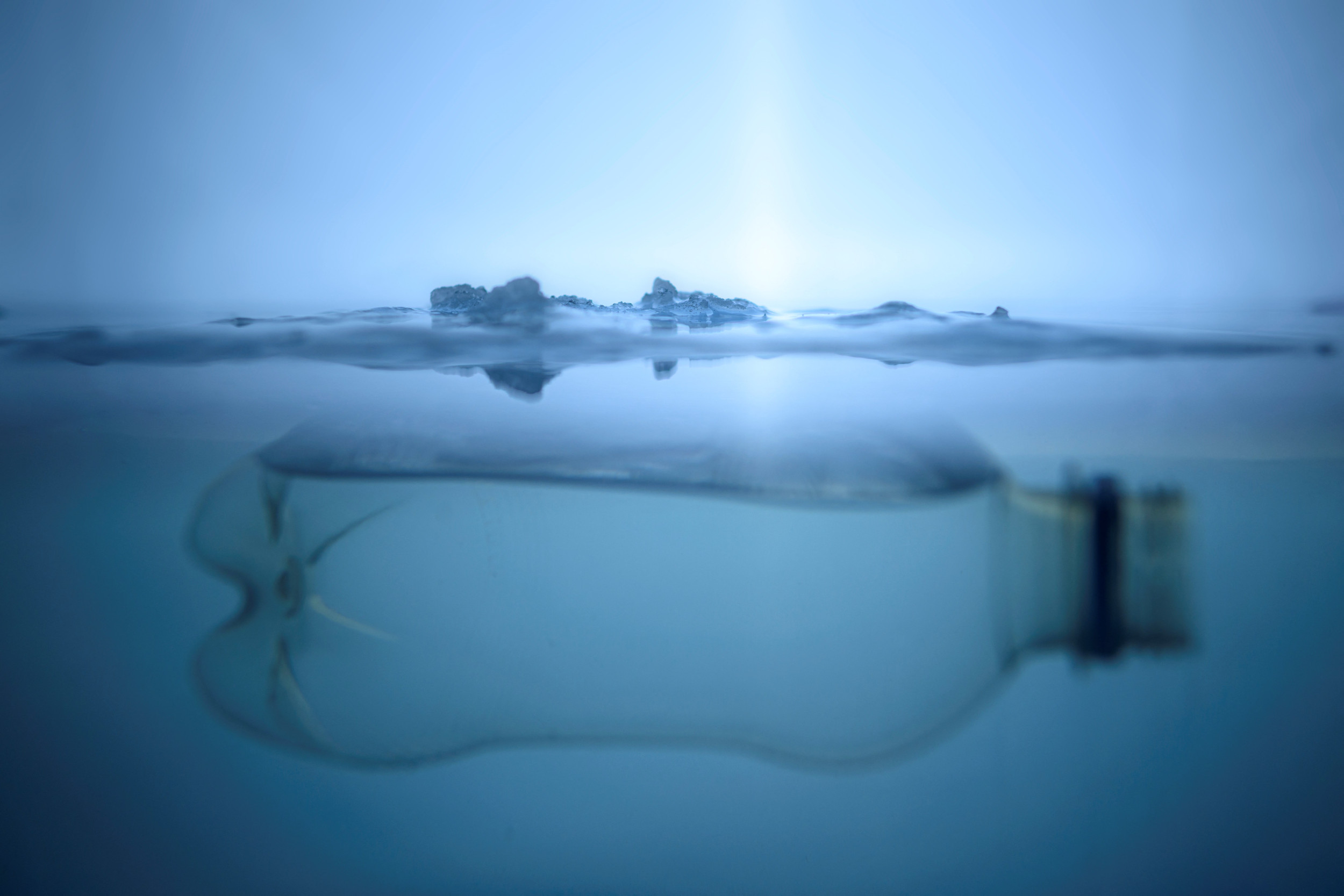 Plastic bottle floating near ice