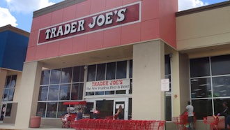 People stand in line waiting to enter Trader Joe's to buy groceries in Pembroke Pines, Fla., on March 24, 2020.