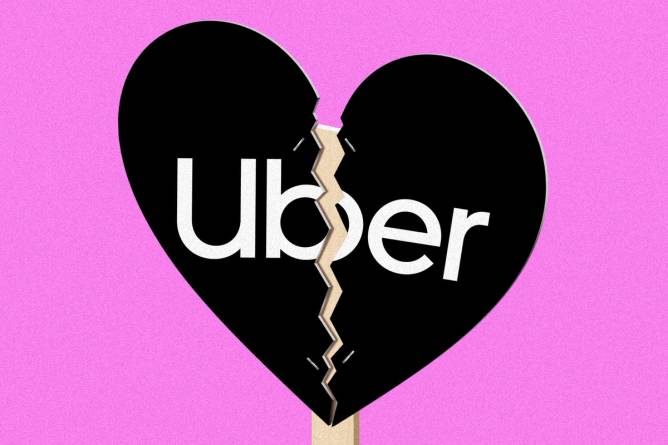 Uber logo on a picket sign in the shape of a broken heart