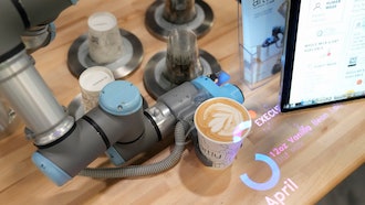 The Artly barista robot serves a drink during the CES tech show, Las Vegas, Jan. 10, 2024.