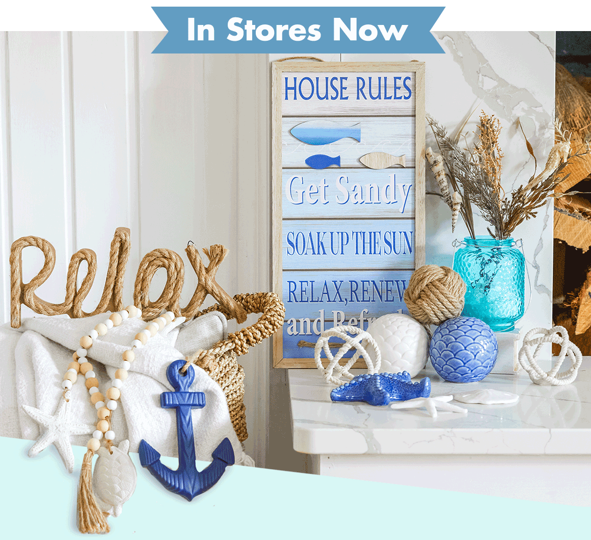 Living room with a “relax” rope sign, beaded garland, anchor décor, beach wall signs, and more beach décor