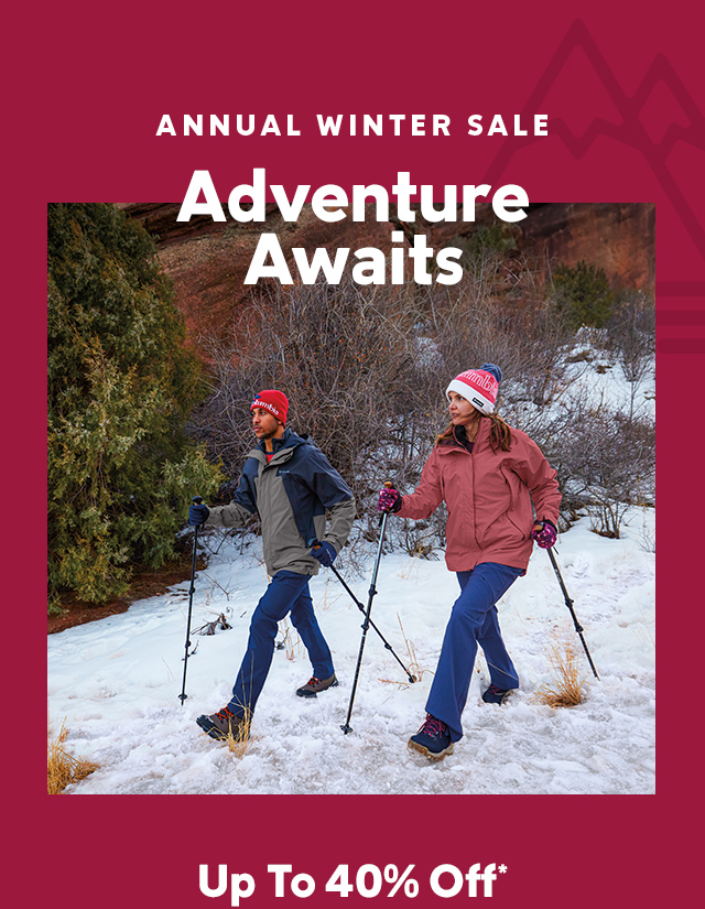 Get up to forty percent off in our annual Winter Sale. A couple hiking in the snow bundled up in cozy gear with headline Adventure Awaits.