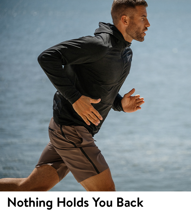 A man running in a Vuori rain jacket.