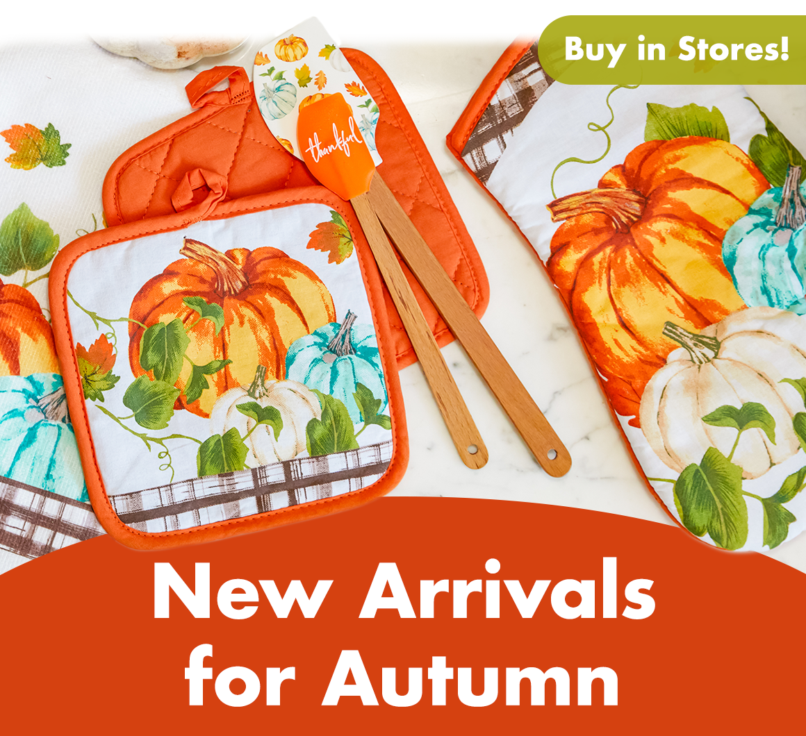 Fall hand towel, hot pads, spatulas, and more on a counter