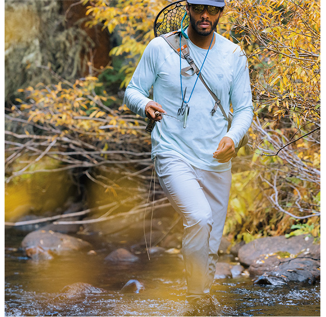 Man wading through river in Men's PFG Uncharted™ Pants