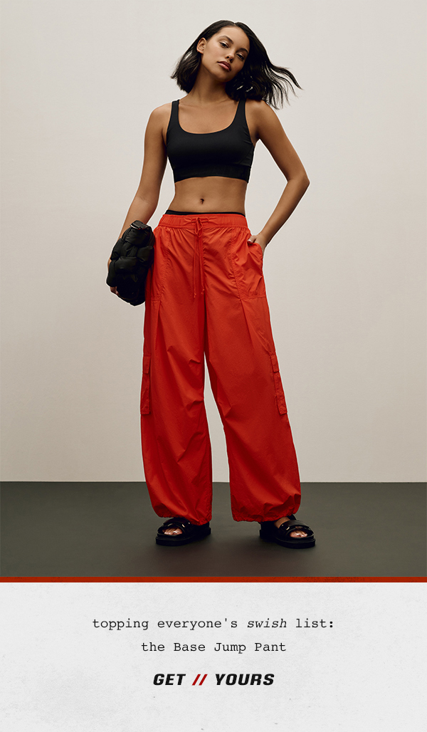 Woman wearing red parachute pants. Get yours.