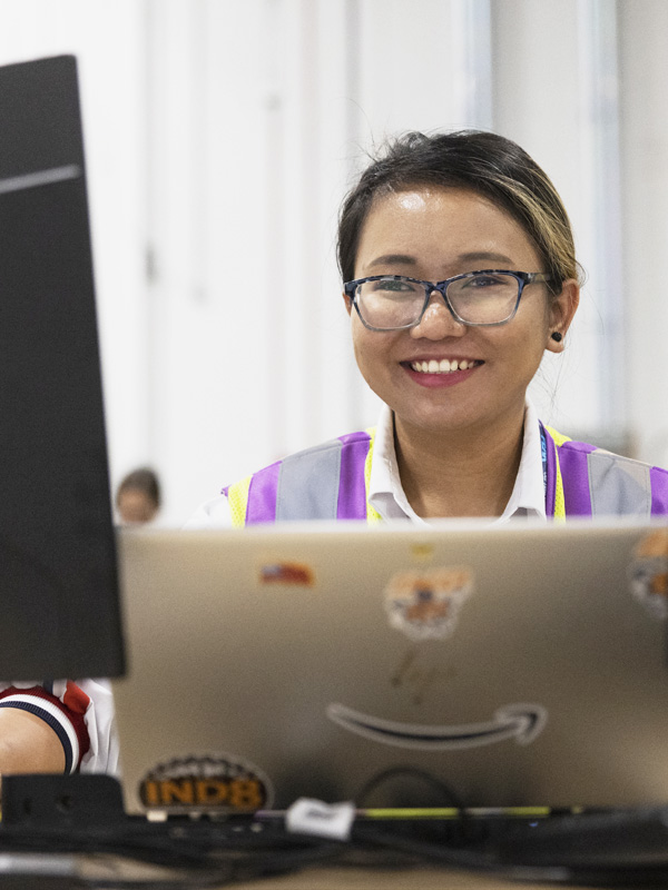 An Amazon employee working on her computer.