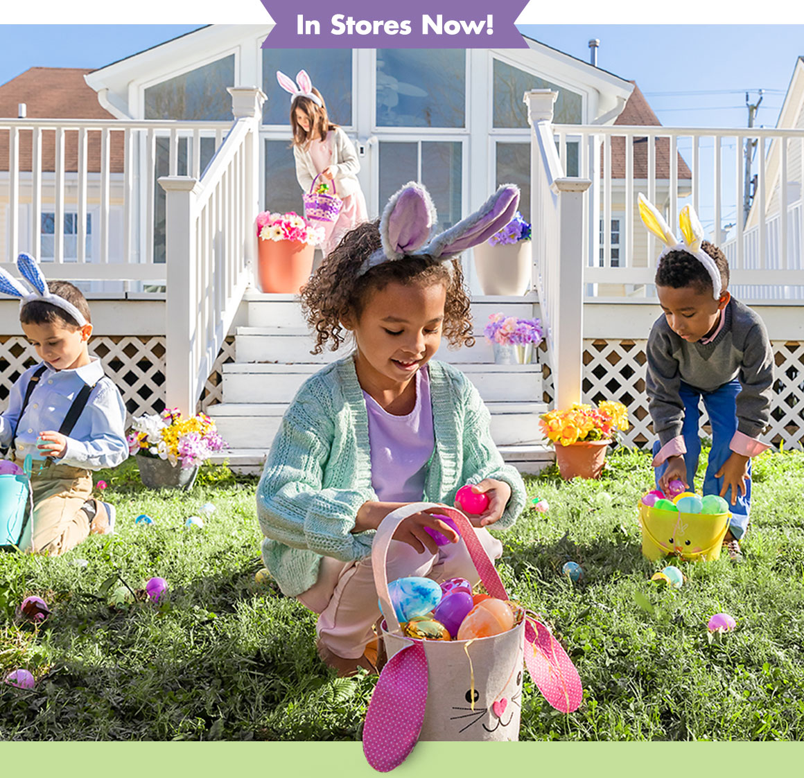 4 children in a backyard with Easter baskets collecting eggs