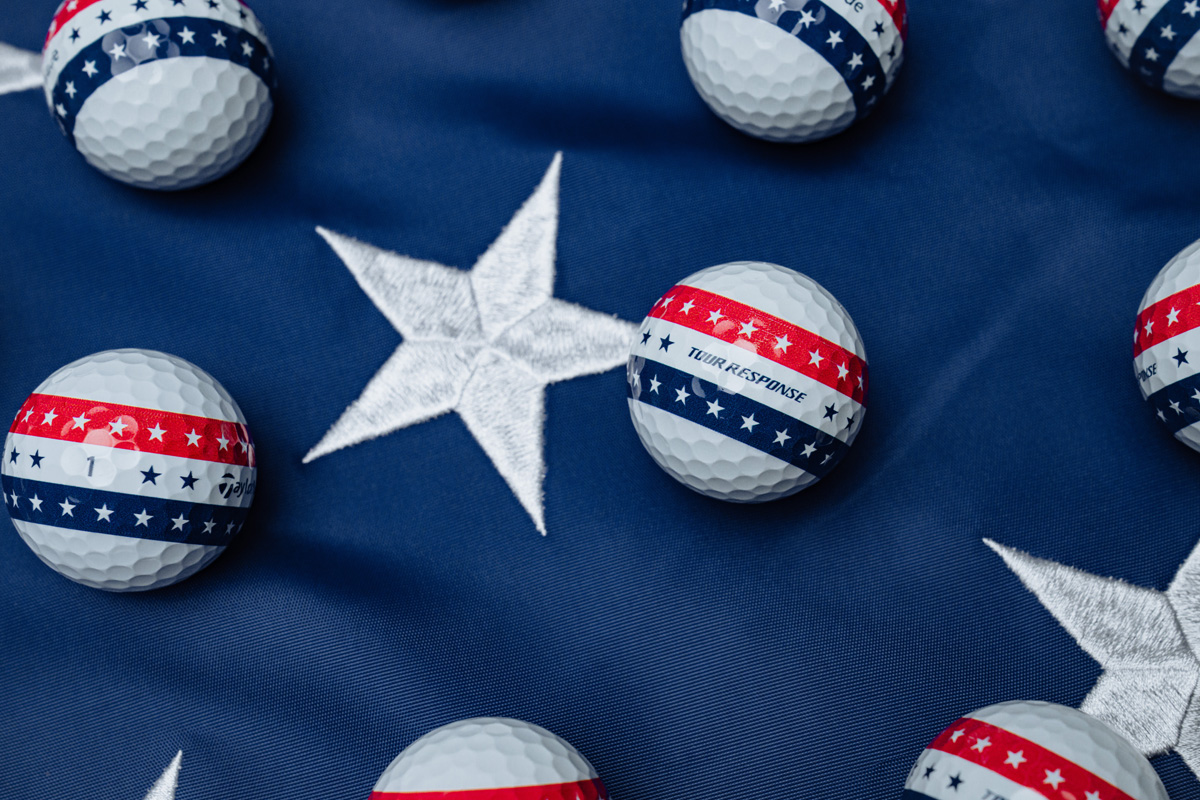 Tour Response Stripe USA golf balls on top of a navy blue and silver star tablecloth