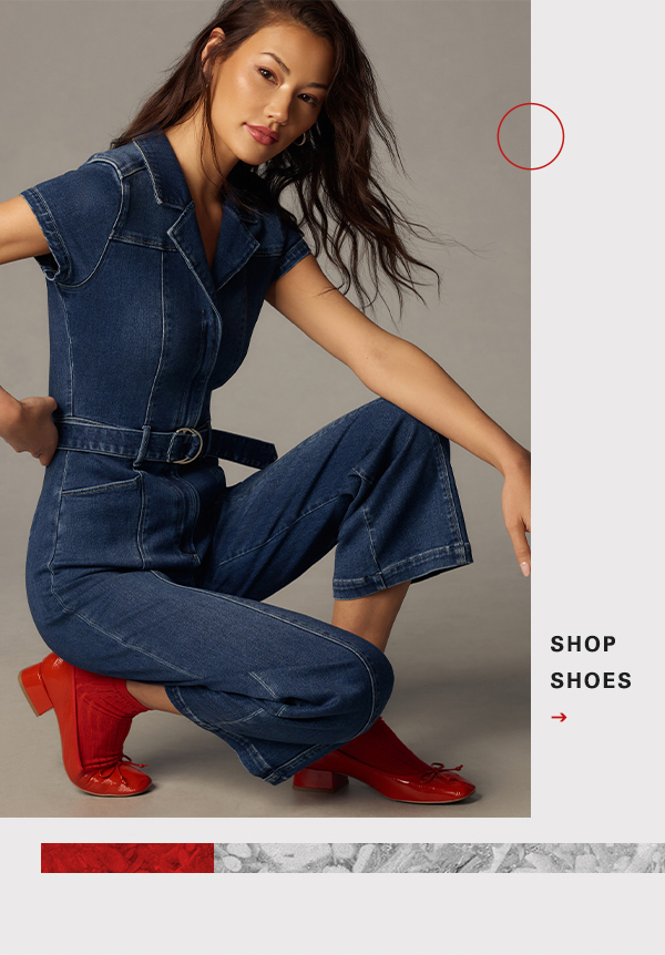 Woman wearing denim jumpsuit and red ballet flats. Shop shoes.