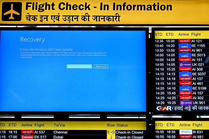 A display screen showing information on flights reflects an error message amid global IT outage at the Indira Gandhi International Airport in New Delhi on July 19, 2024