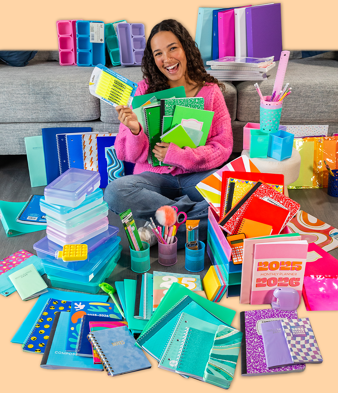 Girl surrounded by piles of colorful school supplies