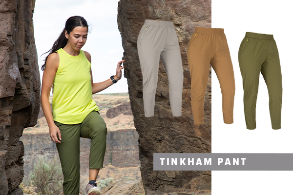 woman hiking up rocks while wearing the tinkham pant