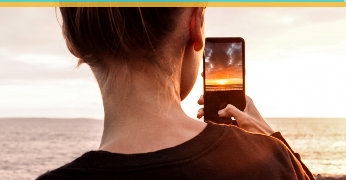 Someone taking a picture of the ocean horizon