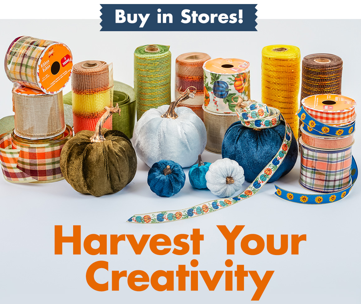 Rolls of fall-themed ribbon and mesh next to several blue decorative pumpkins