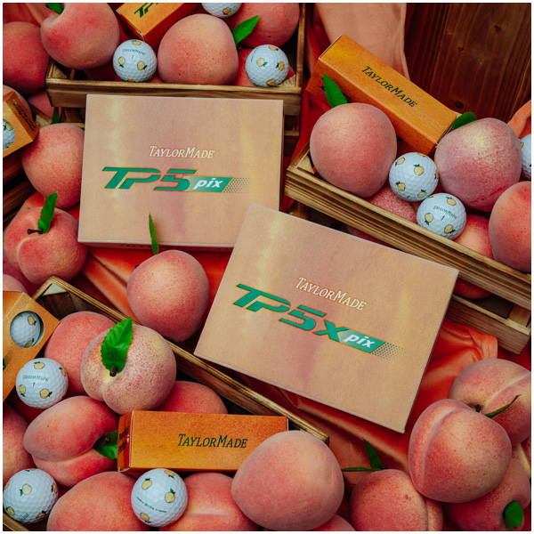 TP5 and TP5x pix peach golf ball boxes and balls on a bed of peaches