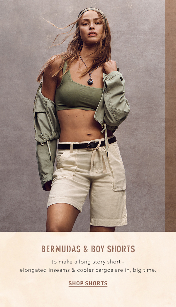 Woman wearing khaki Bermuda shorts. Shop shorts.