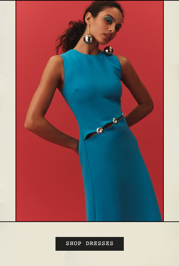 Woman in teal dress. Shop dresses.