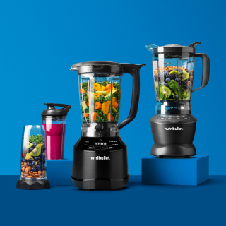 Two full-sized nutribullet blenders on blue background.