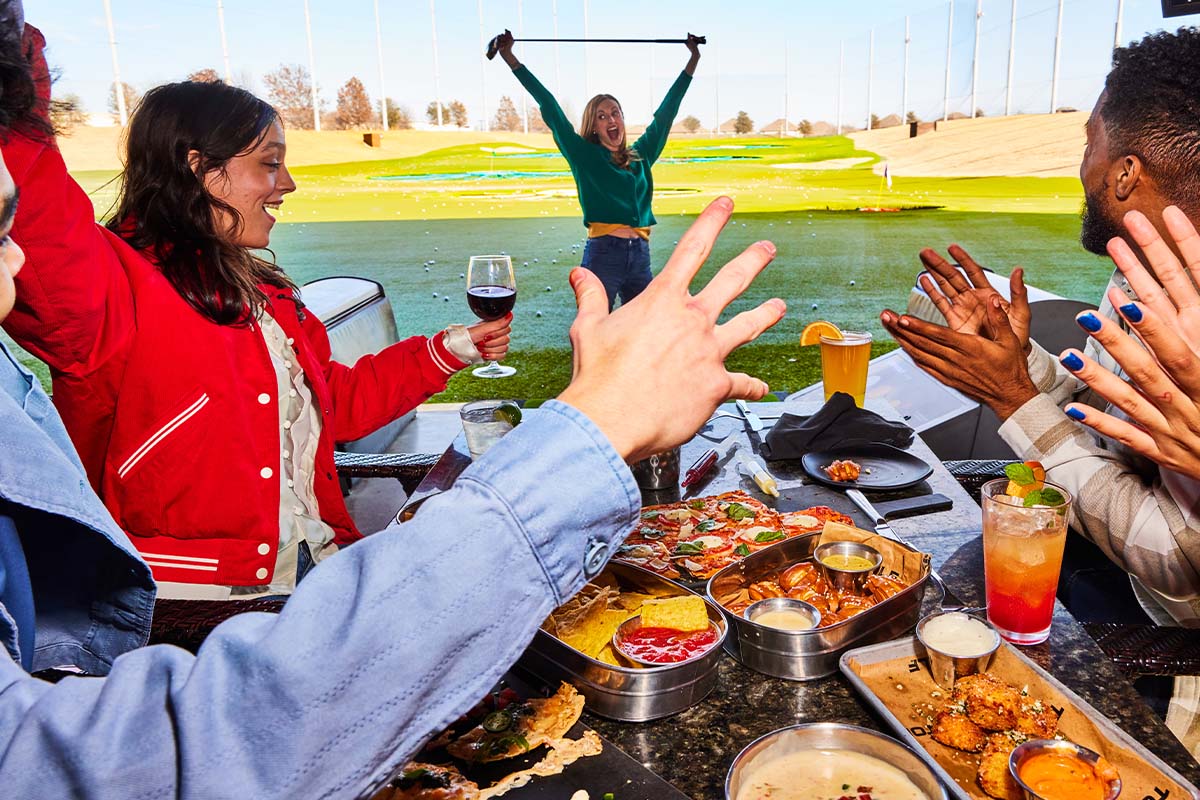 Celebrating in a Topgolf Bay