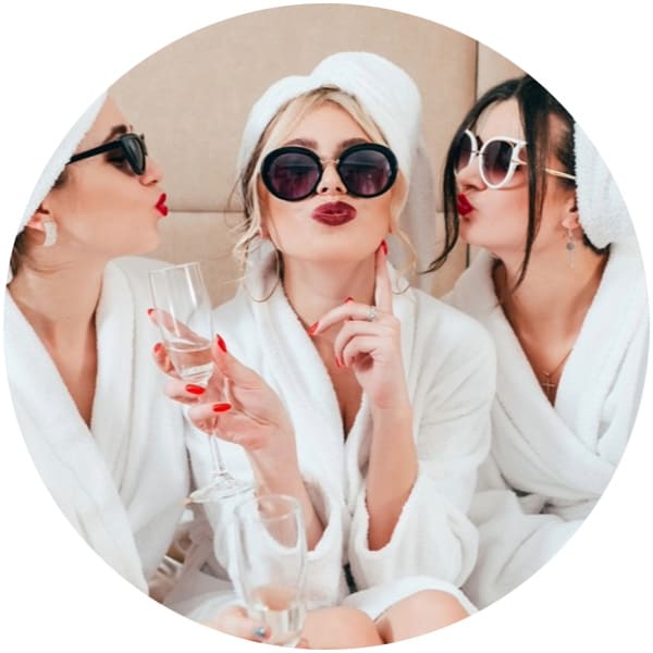 Three women in spa robes and sunglasses