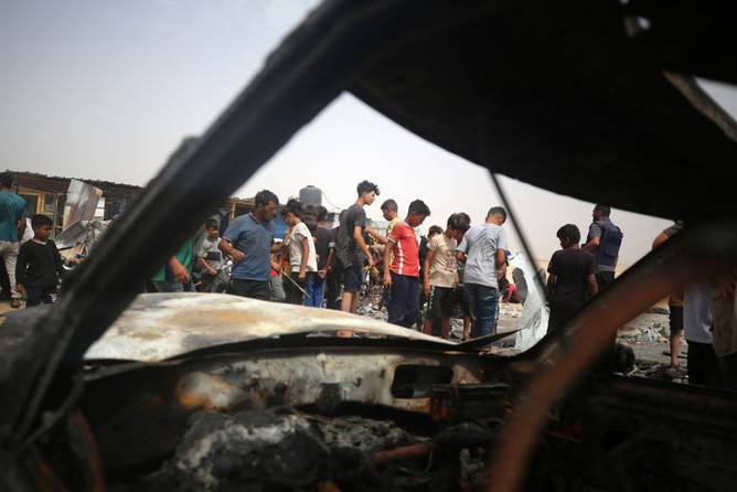 Palestinians are gathering at the site of an Israeli strike on a camp for internally displaced people in Raf