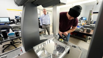 A worker prepares a Hexagon machine at Reata Engineering and Machine Works, Englewood, Colo., Feb. 15, 2024.