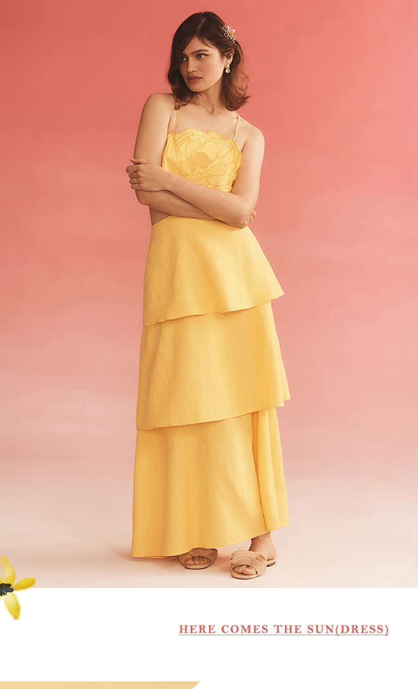 Woman wearing yellow tiered dress. Shop sundresses.