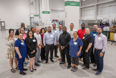 Members of AcariaHealth’s Homescripts team gather in their new, upgraded dispensing pharmacy.