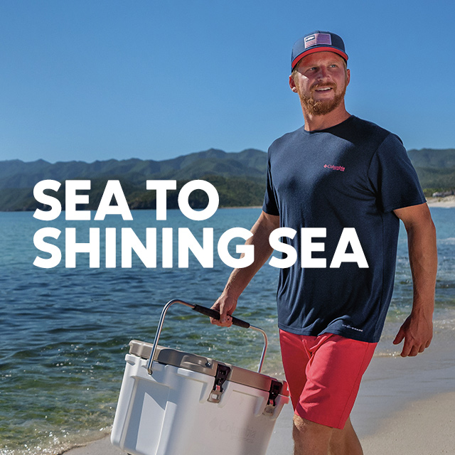 Sea to shining sea. Man in PFG Americana gear on a beach. 