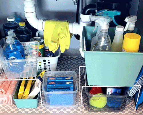 Blog idea: ways to organize under a sink showing organized cleaners, storage bins, and more