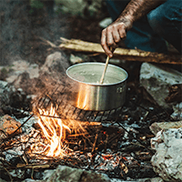 boiling water over a campfire