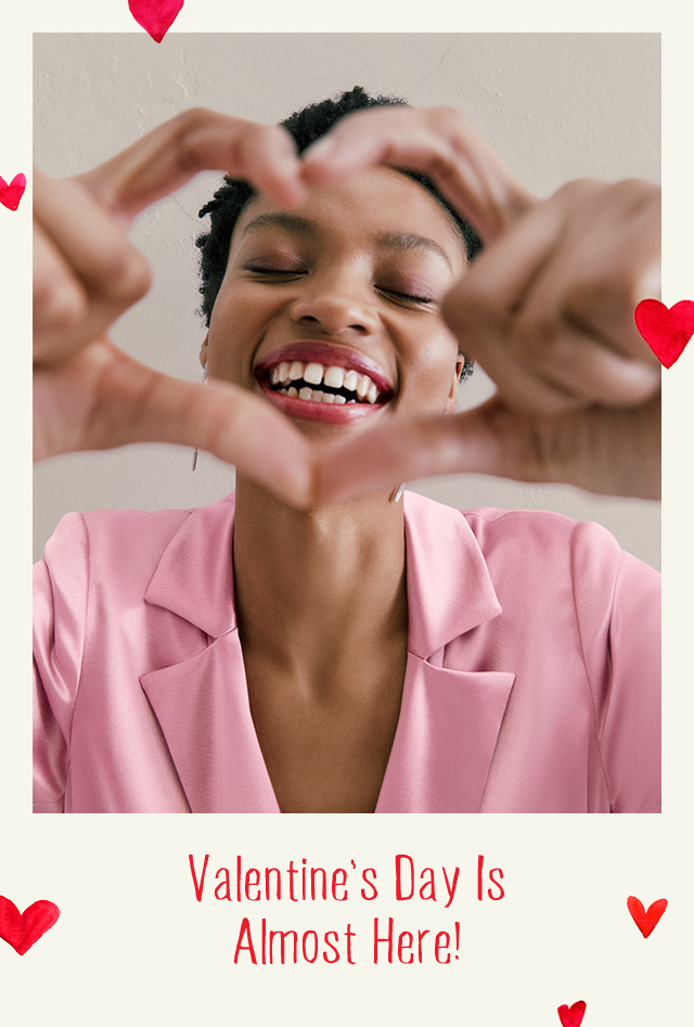 Woman making a heart sign.        