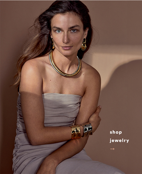 Woman wearing gold and silver jewelry. Shop jewelry.