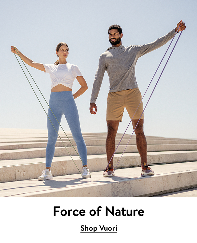 A man and woman wearing activewear and using resistance bands.