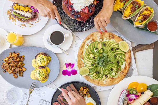 A table of a variety of prepared breakfast dishes