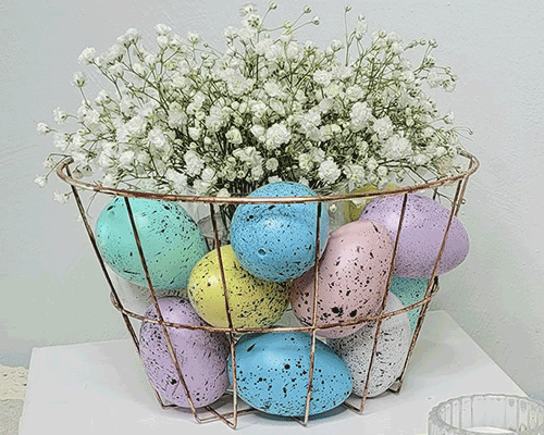 Blog idea: A DIY wire basket with Easter eggs and baby’s breath in it on a hall table