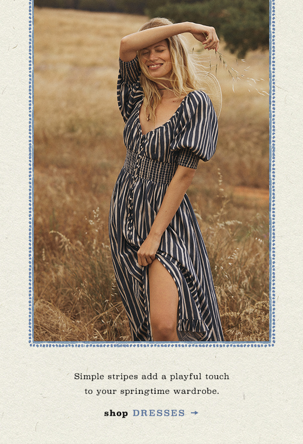 Woman wearing striped dress. Shop dresses.